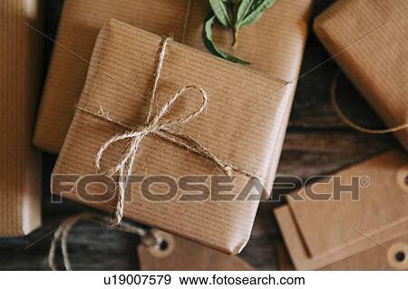 Presents wrapped in brown paper and string View Large Photo Image Stock Photo - Presents wrapped in brown paper and string. Fotosearch