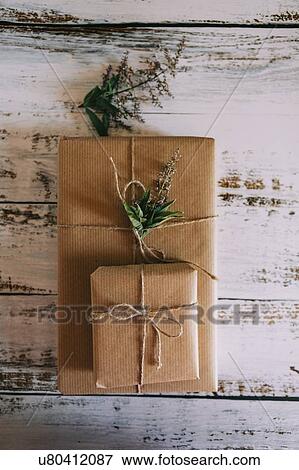 Presents wrapped in brown paper and string with flowers View Large Photo Image Stock Photo - Presents wrapped in brown paper and string with flowers. Fotosearch