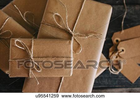 Presents wrapped in brown paper and string View Large Photo Image Stock Photo - Presents wrapped in brown paper and string. Fotosearch