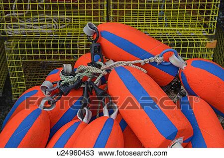 Stock Image - Red and blue buoys by lobster traps. Fotosearch