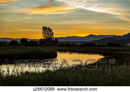 Stock Photo - River at sunset in Picabo, Idaho, USA. Fotosearch