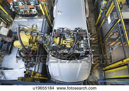Picture - Robot inserting car windscreen in car factory. Fotosearch
