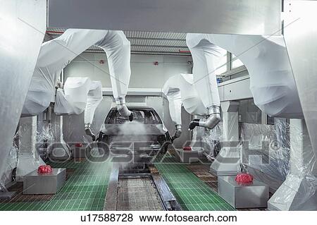 Stock Photo - Robot paint spraying car bodies in car factory. Fotosearch