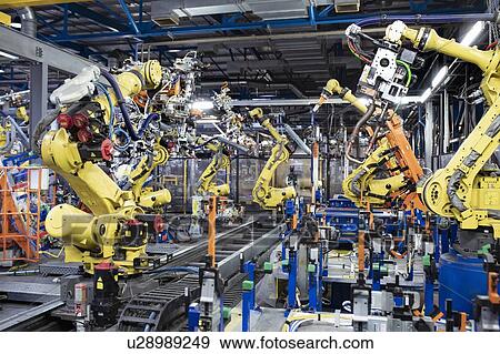 Robots on production line in car factory View Large Photo Image Stock Photo - Robots on production line in car factory. Fotosearch