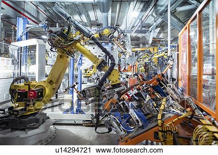 Robots spot welding car parts in car factory View Large Photo Image Stock Image - Robots spot welding car parts in car factory. Fotosearch