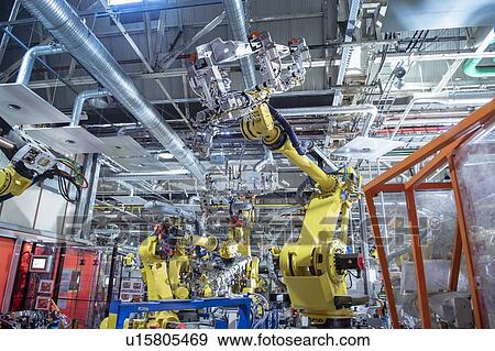 Stock Photo - Robots spot welding car parts in car factory. Fotosearch