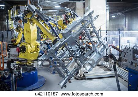 Stock Photo - Robots spot welding car parts in car factory. Fotosearch