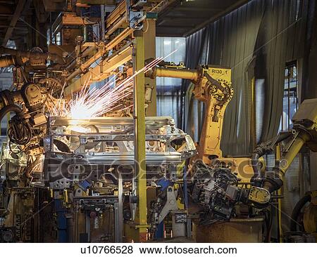Robots welding car bodies in car factory View Large Photo Image Stock Photo - Robots welding car bodies in car factory. Fotosearch