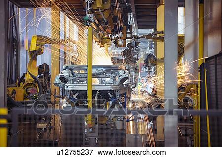 Stock Photo - Robots welding steel car body in car factory. Fotosearch