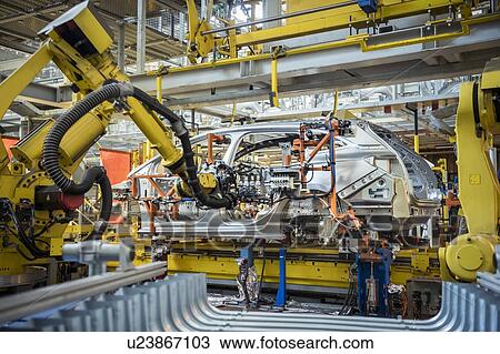 Robots with car body on production line in car factory View Large Photo Image Stock Image - Robots with car body on production line in car factory. Fotosearch