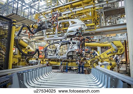 Robots with car body on production line in car factory View Large Photo Image Stock Photography - Robots with car body on production line in car factory. Fotosearch