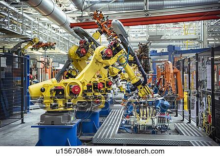 Picture - Robots with car parts in car factory. Fotosearch