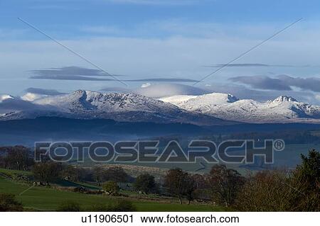 Stock Image - Scenic landscape with distant snow capped mountains, Llanberis, Gwynedd, Wales. Fotosearch