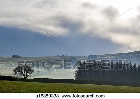 Stock Photo - Scenic landscape with rolling hills and valley mist, Llanberis, Gwynedd, Wales. Fotosearch