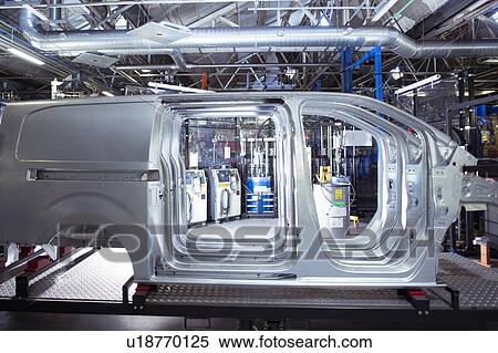 Stock Photography - Side view of van bodies on production line in car factory. Fotosearch