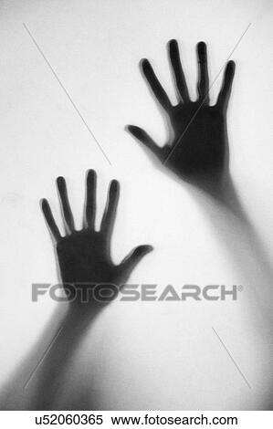 Stock Photography - Silhouette of woman's hands touching frosted glass. Fotosearch