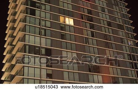 Single lit window in modern apartment block View Large Photo Image Stock Image - Single lit window in modern apartment block. Fotosearch