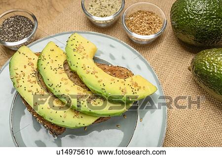 Sliced avocado on toast with seeds View Large Photo Image Stock Image - Sliced avocado on toast with seeds. Fotosearch