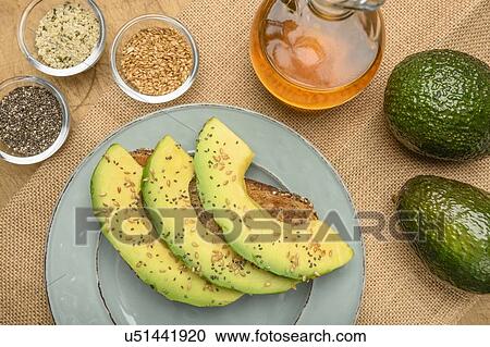 Sliced avocado on toast with seeds View Large Photo Image Stock Image - Sliced avocado on toast with seeds. Fotosearch