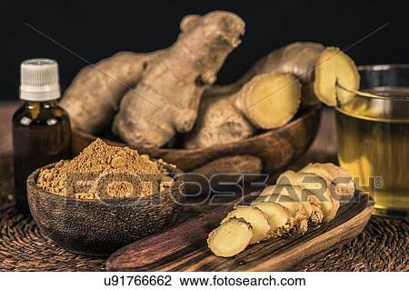 Stock Image - Sliced ginger root and ginger powder in the bowl. Fotosearch