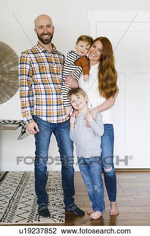 Smiling family in home View Large Photo Image Stock Image - Smiling family in home. Fotosearch