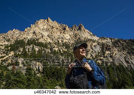 Smiling man hiking on Sawtooth Mountains in Stanley, Idaho, USA View Large Photo Image Stock Image - Smiling man hiking on Sawtooth Mountains in Stanley, Idaho, USA. Fotosearch
