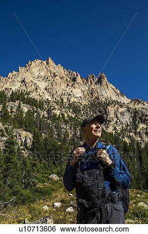 Stock Photograph - Smiling man hiking on Sawtooth Mountains in Stanley, Idaho, USA. Fotosearch