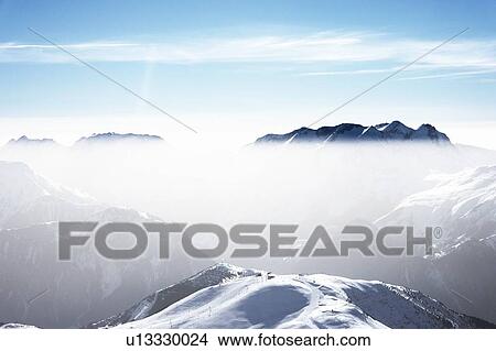 Snow covered mountain landscape with mist, Alpe-d'Huez, Rhone-Alpes, France View Large Photo Image Picture - Snow covered mountain landscape with mist, Alpe-d'Huez, Rhone-Alpes, France. Fotosearch