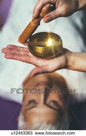 Stock Image - Sound healing meditation therapy. Fotosearch