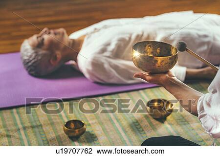 Stock Image - Sound healing meditation therapy. Fotosearch