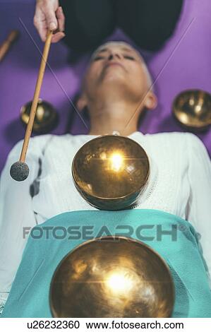 Stock Image - Sound healing meditation therapy. Fotosearch