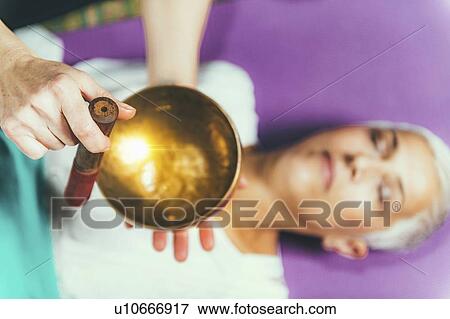 Stock Photo - Sound healing meditation therapy. Fotosearch