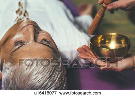 Stock Photo - Sound healing meditation therapy. Fotosearch
