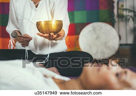 Stock Photo - Sound healing meditation therapy. Fotosearch