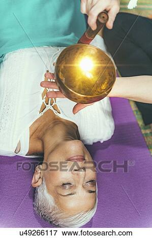 Stock Photo - Sound healing meditation therapy. Fotosearch