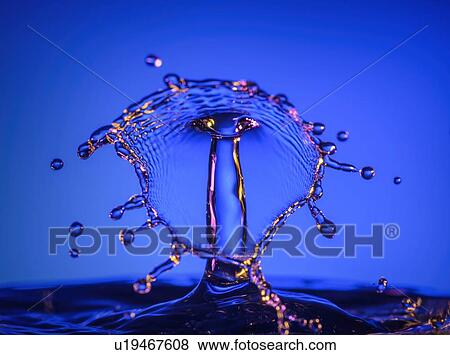 Stock Photo - Splashing water against blue background. Fotosearch