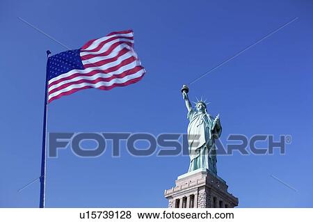 Stock Photo - Statue of Liberty and US flag. Fotosearch