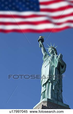 Stock Photography - Statue of Liberty and US flag. Fotosearch