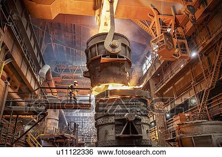 Steelworker starting molten steel pour in steelworks View Large Photo Image Stock Photograph - Steelworker starting molten steel pour in steelworks. Fotosearch