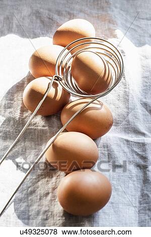 Stock Photo - Still life of eggs and kitchen utensil, overhead view. Fotosearch