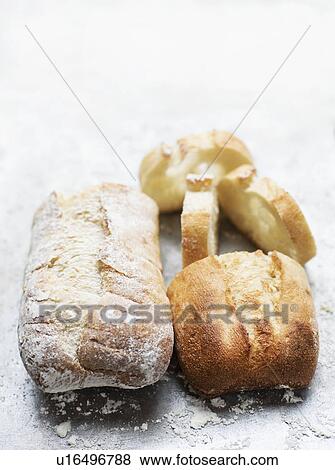 Still life of floured and unfloured ciabatta loaf on baking tray, overhead view View Large Photo Image Stock Photo - Still life of floured and unfloured ciabatta loaf on baking tray, overhead view. Fotosearch