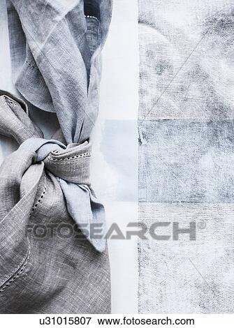 Stock Photo - Still life of tied blue napkins on table, overhead view. Fotosearch