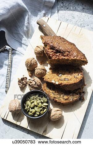 Still life of walnut and pumpkin seed cake sliced on cutting board, overhead view View Large Photo Image Stock Image - Still life of walnut and pumpkin seed cake sliced on cutting board, overhead view. Fotosearch