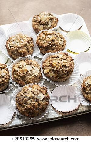 Still life of wholemeal muffins and cake cases on baking tray, overhead view View Large Photo Image Stock Photography - Still life of wholemeal muffins and cake cases on baking tray, overhead view. Fotosearch