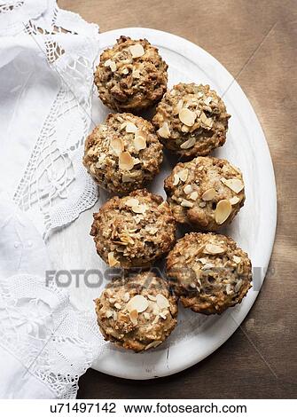 Stock Image - Still life of wholemeal muffins on plate, overhead view. Fotosearch