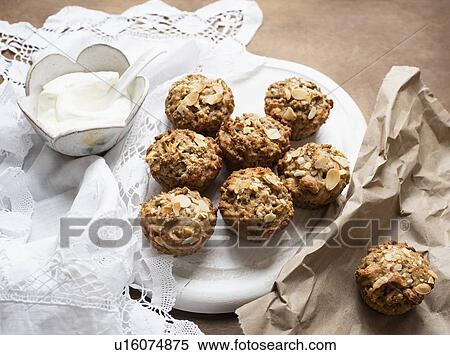 Still life of wholemeal muffins on plate with bowl of soft cheese, overhead view View Large Photo Image Stock Photography - Still life of wholemeal muffins on plate with bowl of soft cheese, overhead view. Fotosearch