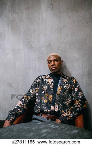 Stock Photography - Stylish man, concrete wall background. Fotosearch