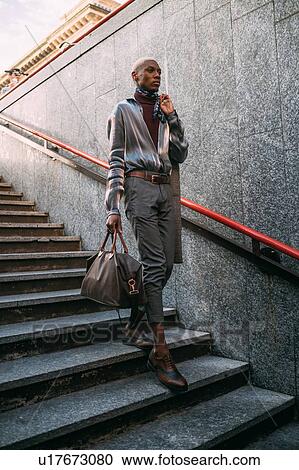 Stylish man going into subway station, Milan, Italy View Large Photo Image Stock Image - Stylish man going into subway station, Milan, Italy. Fotosearch