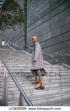 Stylish man going up stairs, Milan, Italy View Large Photo Image Stock Photo - Stylish man going up stairs, Milan, Italy. Fotosearch