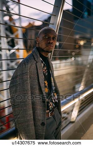 Stylish man leaning against bridge railings, Milan, Italy View Large Photo Image Stock Photography - Stylish man leaning against bridge railings, Milan, Italy. Fotosearch